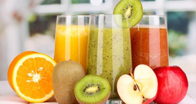 Orange, Kiwi and Apple Juice in Glasses on Table with Fresh Fruit