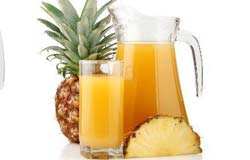 Glass and Pitcher of Pineapple Juice with Fresh Pineapple