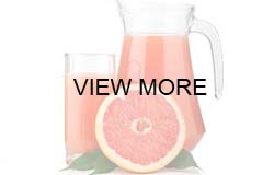 Glass and Pitcher of Grapefruit Juice with Fresh Grapefruit